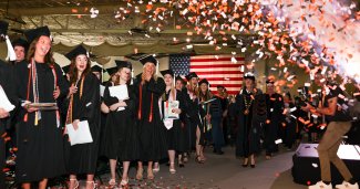 Photo of ONU commencement with students and a confetti cannon