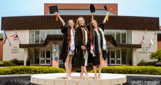 Photo of the Fisher sisters in thier caps and gowns