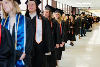 Photo of students in cap and gown for graduation