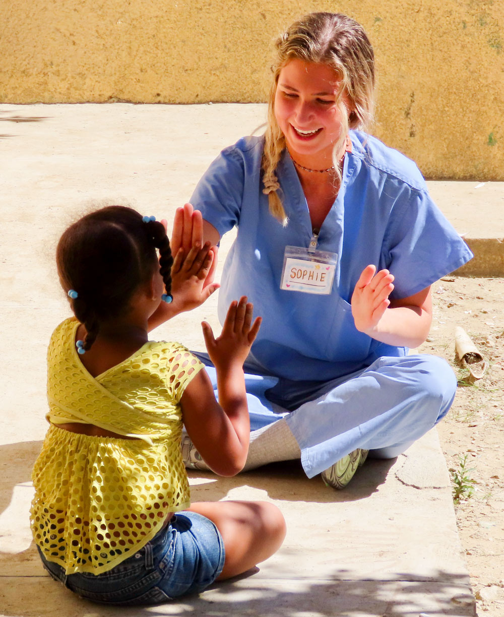 Public health student mentoring a child in the Dominican Republic.