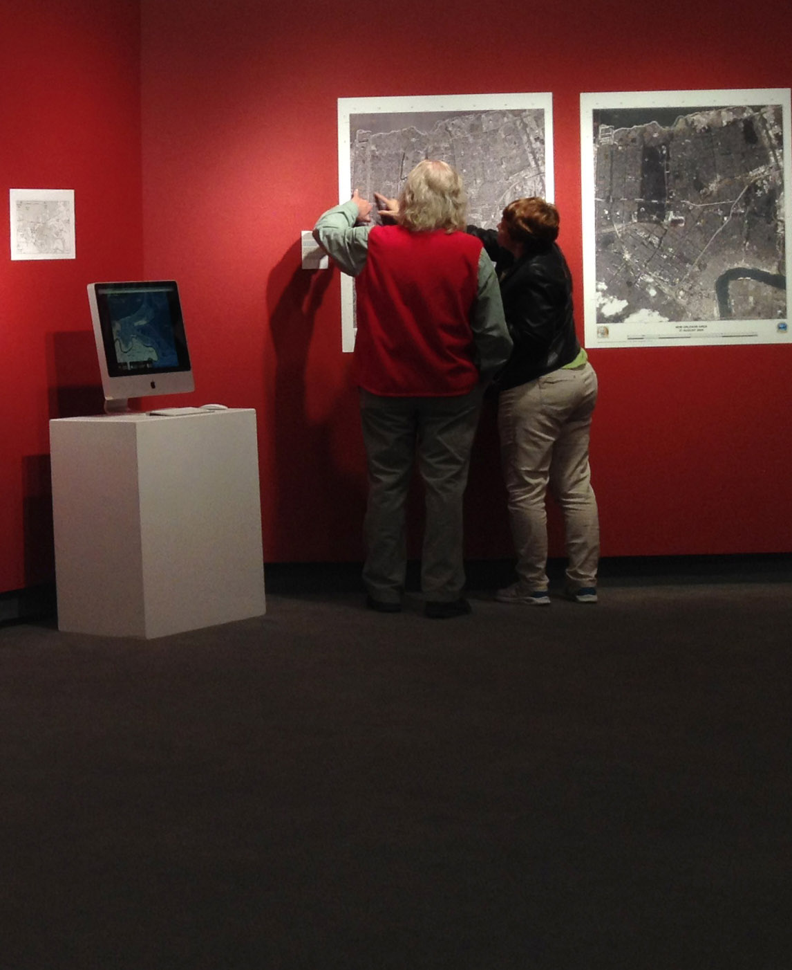 People walking around and looking at a gallery exhibit. 
