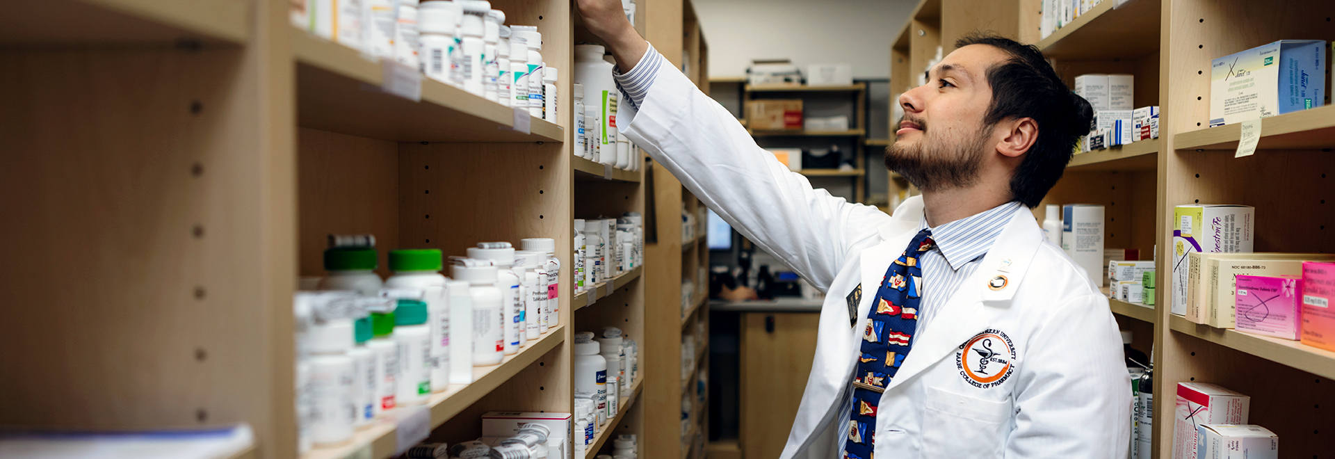 student working in the retail pharmacy on campus