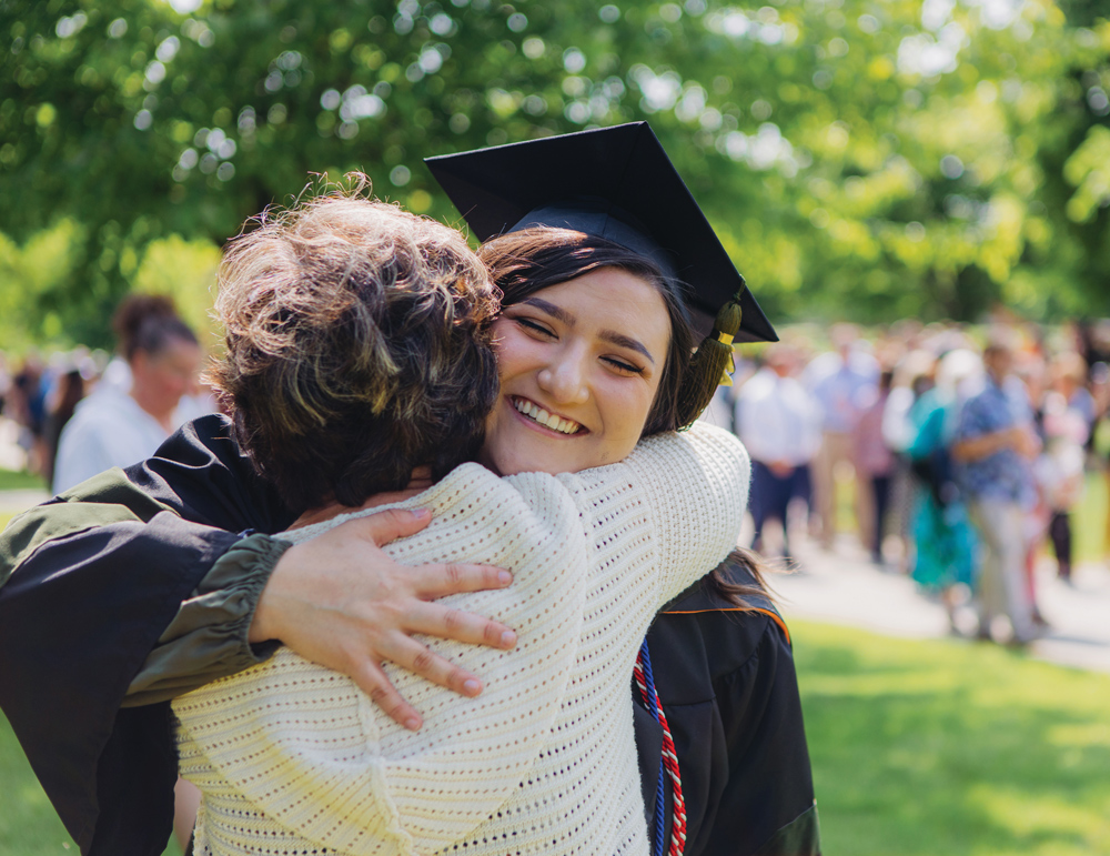 Photo of an ONU graduate student hugging a family member