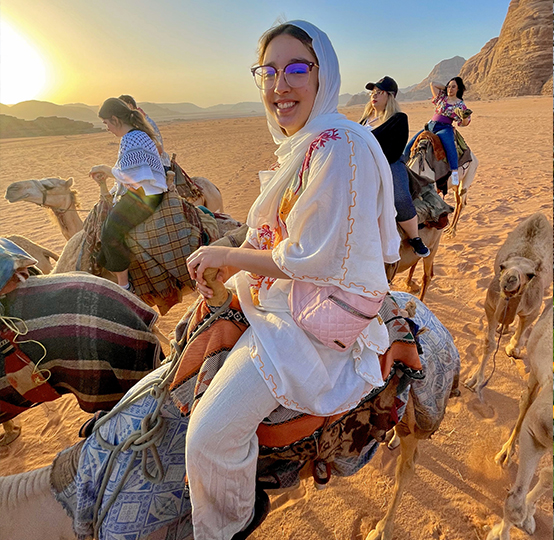 Photo of Juliana riding on a camel