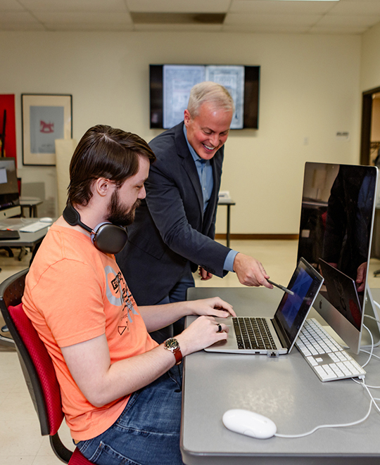 Photo of Art and Design class, ONU student and faculty sitting behind a desktop