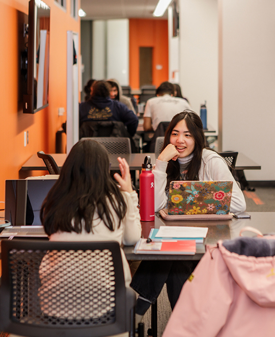 Photo of tables in the ONU Student Success Center with students seated chatting