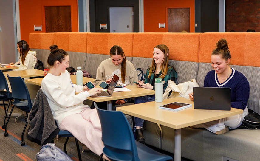 Photo of ONU students sitting at a booth conversing