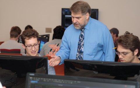 Photo of ONU Faculty Fellow behind a computer teaching