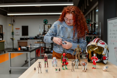 Photo of Lynncoln working with her star wars toys