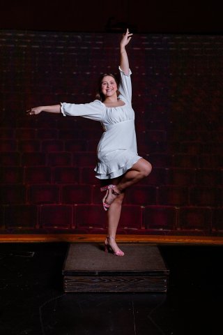 Photo of Kennedy on the stage in a dance pose