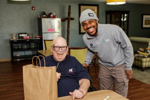 Photo of ONU student delivering packed care packages