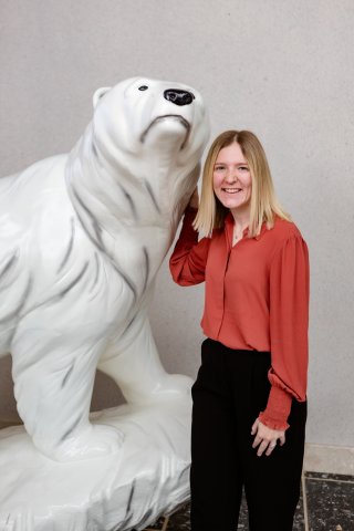 Photo of Becca next to a Polar Bear Statue