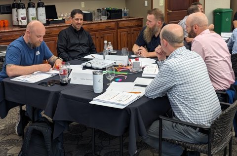 Photo of another classroom meeting at a table