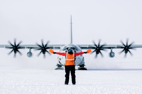 Photo of Lauren with a plane at the distance