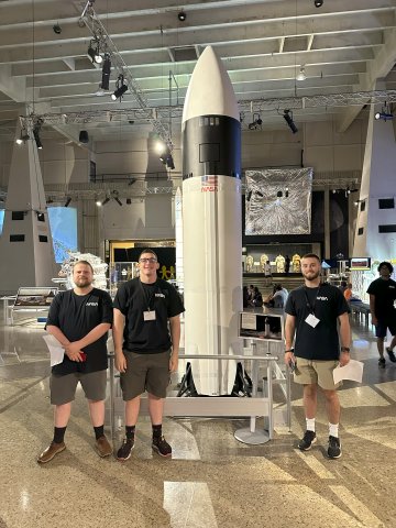 Photo of ONU students in front of a NASA rocket