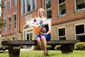 A photo of ONU English Professor with her book of fantasy fiction