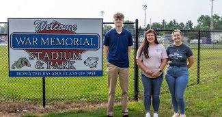 Photo of ONU business students next to park sign