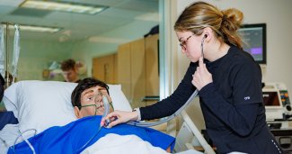 Photo of ONU Nursing student working on a mannequin  