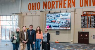 Photo of New ONU video sports board with the people in front of it who donated for it.