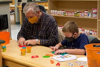 Benjamin Rush, 8, and his grandfather, George Gulbis, after Benjamin received his first COVID-19 vaccine dose.