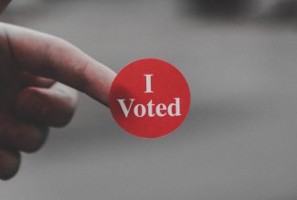 A red-and-white "I voted" sticker.