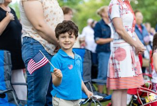 Boy waving flag at Ohio Northern University's Patriotic Pops '21 concert.