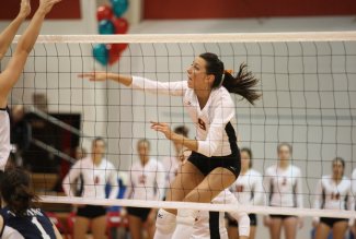 Ohio Northern University student-athlete Liz (Schnelle) Watson delivers a spike during a volleyball game.