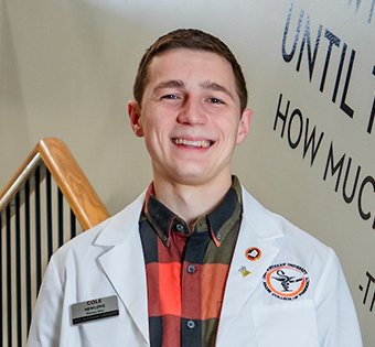 Photo of Cole in his Pharmacy White Coat